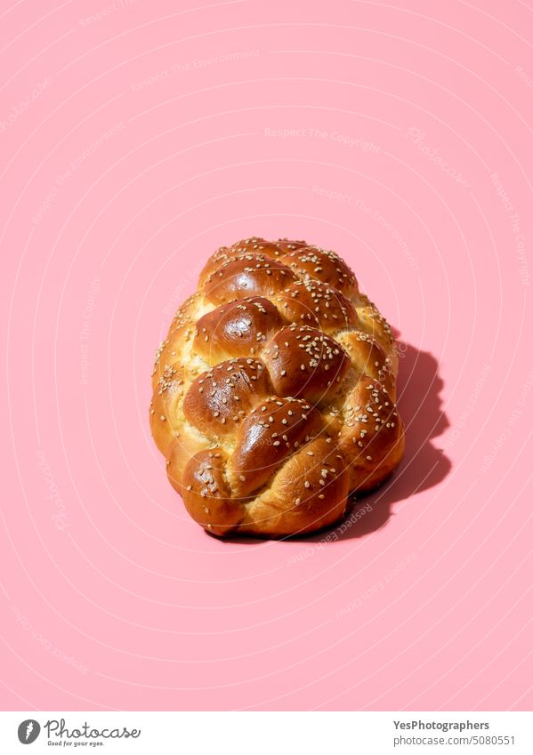 Homemade challah bread isolated on a pink background Sabbath above baked bakery braided breakfast bright celebration close-up color copy-space crust cuisine