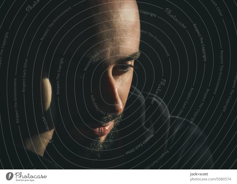 mindful and alert between light and shadow Man Human being Facial hair Face portrait Sunlight Shadow Silhouette dark background Neutral Background Adults