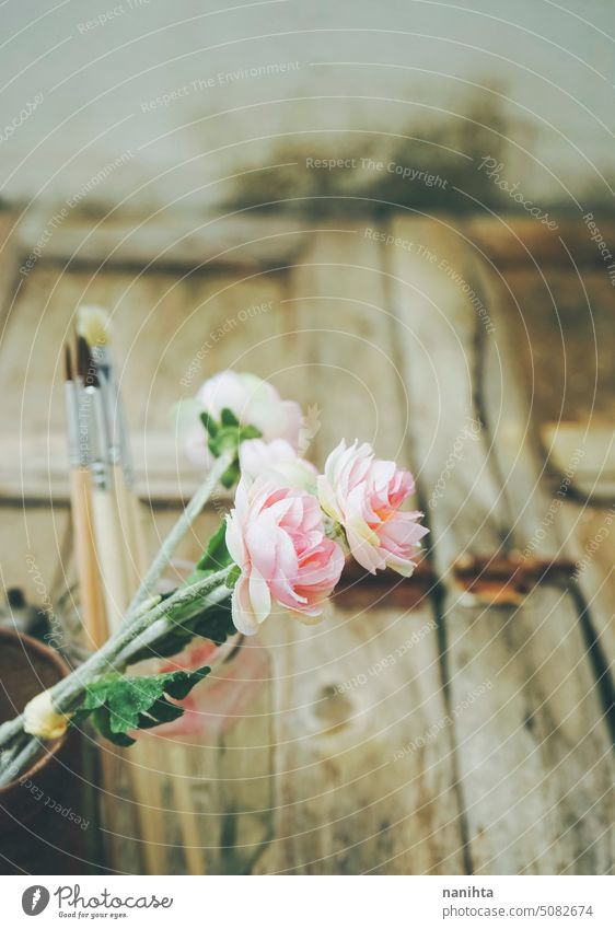 Romantic and nostalgic background with flowers and brushes against old wooden texture romantic rustic art aged vintage retro bouquet rusty artistic poetry mood