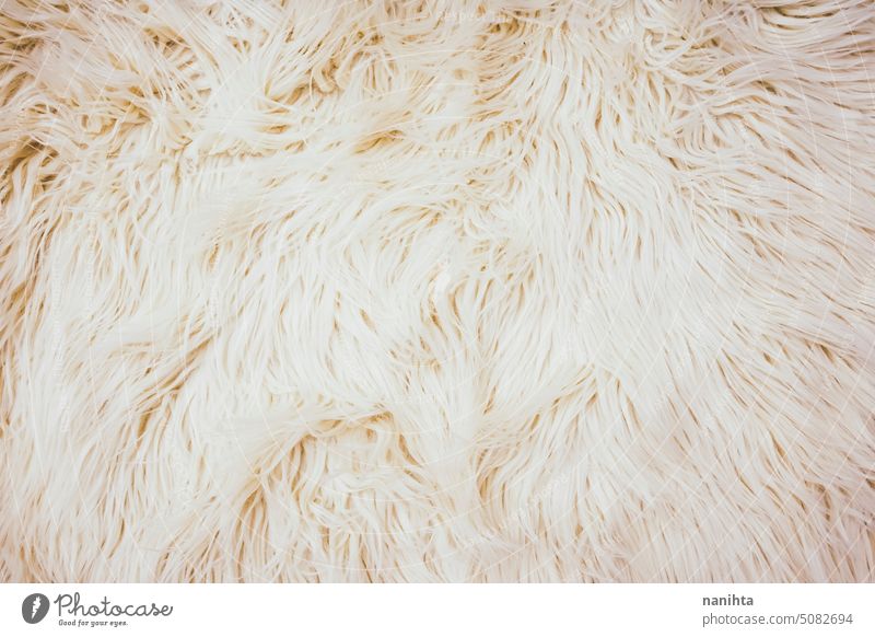 Beige and cozy textured background of artificial fur warm soft beige neutral tones warmth textile animal fur false decor decoration trendy winter fall autumn
