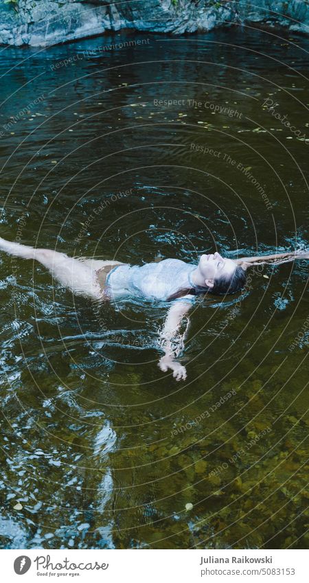 Woman swimming in a cold lake Swimming & Bathing Water Summer be afloat Vacation & Travel Blue Ocean Waves Dive Wet Lake Relaxation Idyll Young woman River
