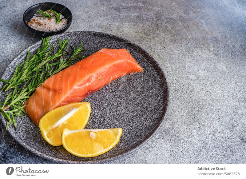 Healthy plate with salmon fish eat eating food healthy herb lemon meal rosemary salt slice spice stone plate nutrition culinary yummy gastronomy dish restaurant