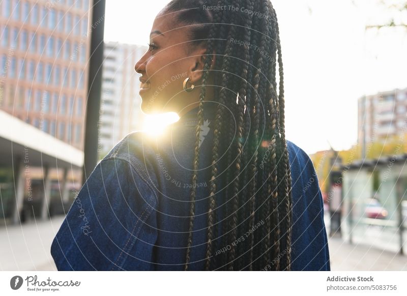 Black woman with Afro braids standing on street city square building afro braids urban chill sunshine daytime african american black ethnic female young lady
