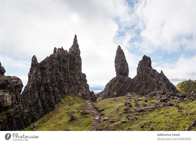 Rocky formations in mountainous valley scenery rock stone hill nature travel person arms outstretched skye island scotland europe storr landscape aged old