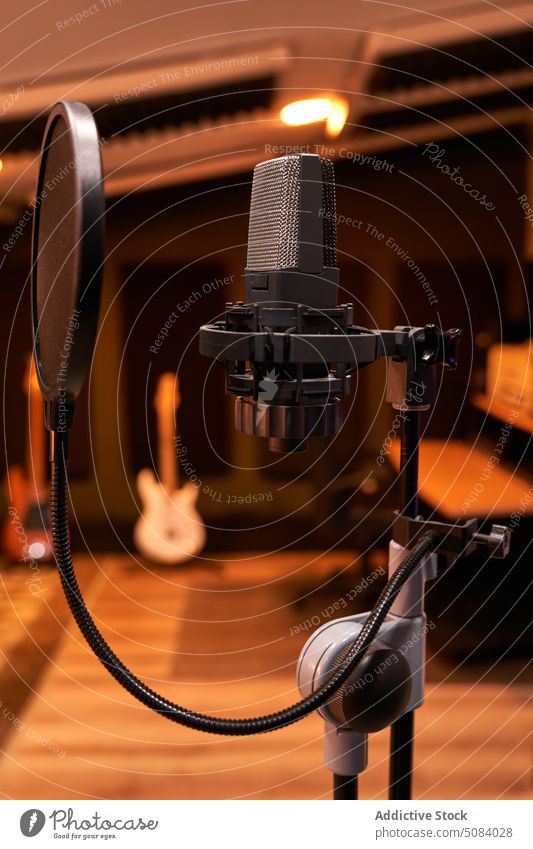 Modern professional microphone in recording studio equipment tripod audio shock mount pop filter broadcast music media sing tool radio voice sound instrument