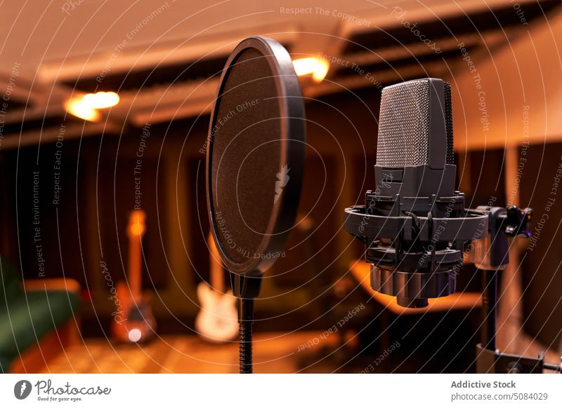 Modern professional microphone in recording studio equipment tripod audio shock mount pop filter broadcast music media sing tool radio voice sound instrument