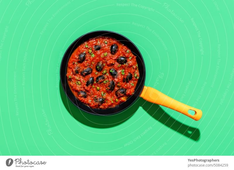 Pasta tomato sauce, italian recipe, above view on a green background bright capers carbs color cooked cooking copy space creative cuisine cut out delicious