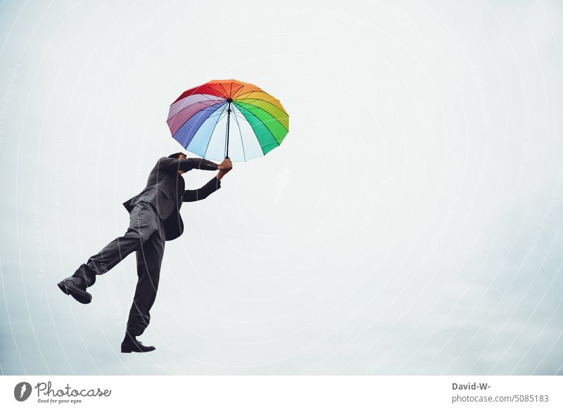 Man flying through the air with an umbrella Umbrella Flying Dream dream Creativity Clouds Sky Freedom Air Weightlessness variegated Hover Happy