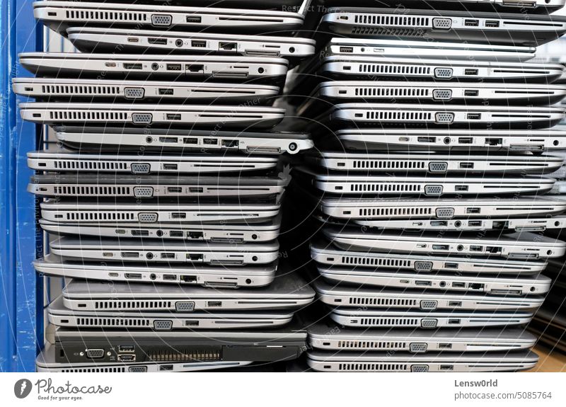 Big stacks of discarded laptops, notebooks on a trolley broken damaged e-waste electrical equipment electronic waste electronics industry environment garbage