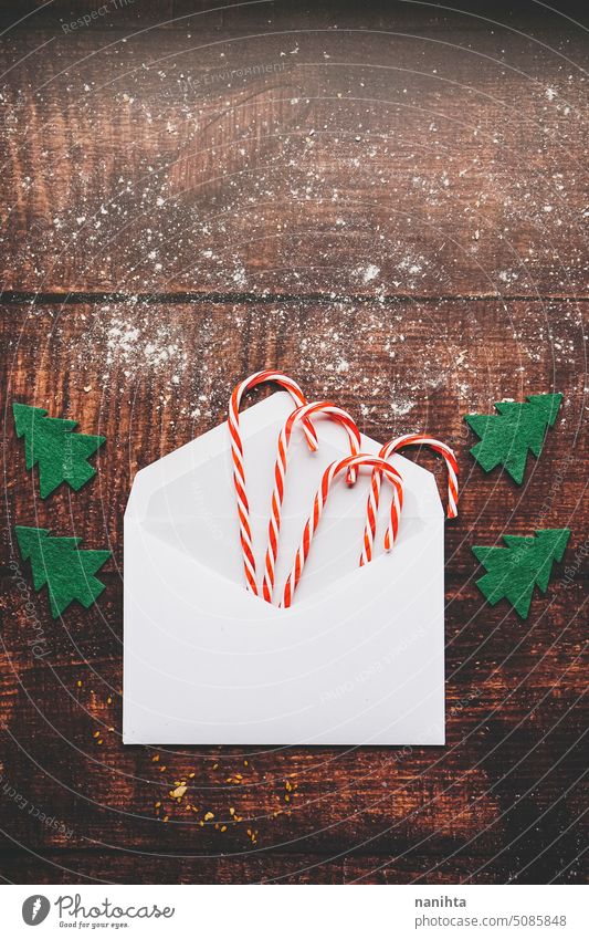 Christmas flatlay with a envelope full of candy canes against a rustic wooden background christmas mockup flat lay texture classic traditional tree snow paper