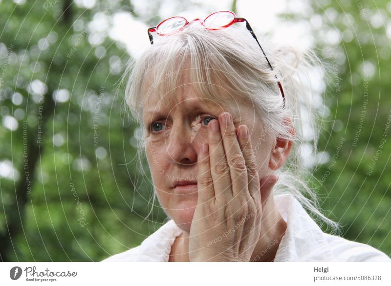 Toothache - portrait of senior woman with gray hair holding a hand to her aching cheek Human being Woman Senior citizen Hand Cheek Looking Face Gray-haired