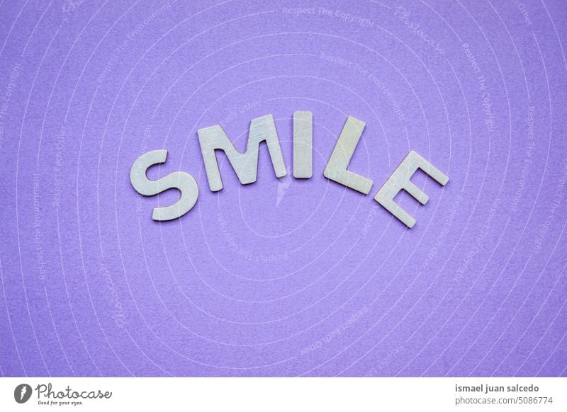 smile word on de purple background, feelings and emotions letters happy happiness notice message post it positive positivity greeting cheers text concept design