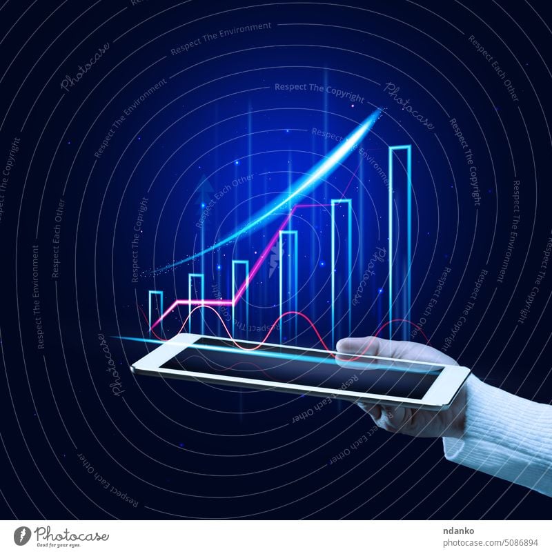 A woman's hand holds a tablet with a holographic chart on a blue background. Sales growth goal growing business profit progress report sale statistic concept