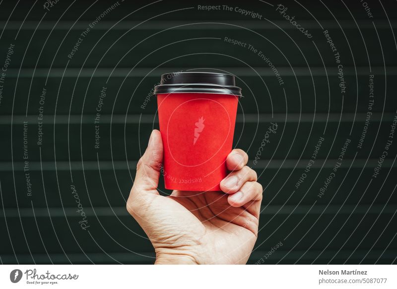 Hand of a man holding a red paper cup coffee beverage isolated background closeup cappuccino drink hand hot drink food mug design male bottle lid take-away