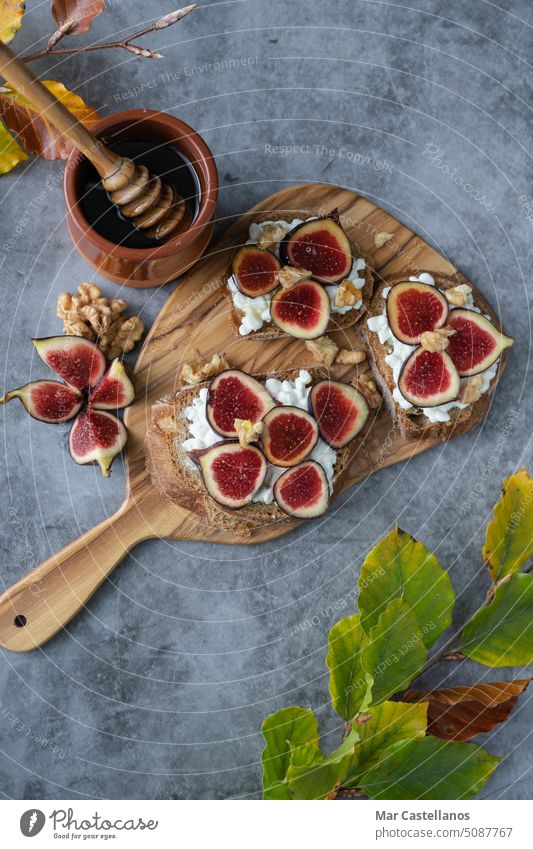 Toast with figs, cheese and honey on a stone slab. Copy space. vertical photo. nuts toast cut top view copy space fall decor autumn food delicious nutritious
