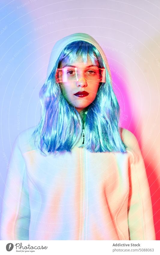 Futuristic woman with transparent goggles and virtual screen model innovation hi tech cyber portrait device illuminate neon future concentrate female red lips