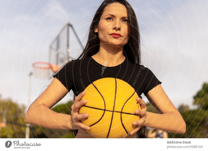 Sportswoman playing basketball on court throw streetball game training hobby sport practice sporty active sportswoman energy determine athlete hoop motivation