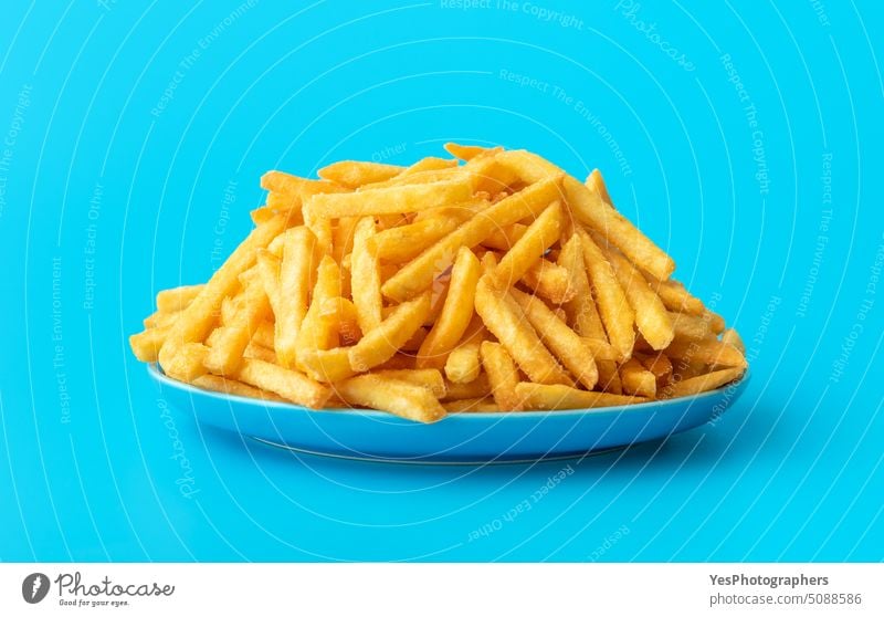 French fries on a plate isolated on a blue background abundance bright calories chip close-up color concept copy space crispy cuisine cut out deep-fried
