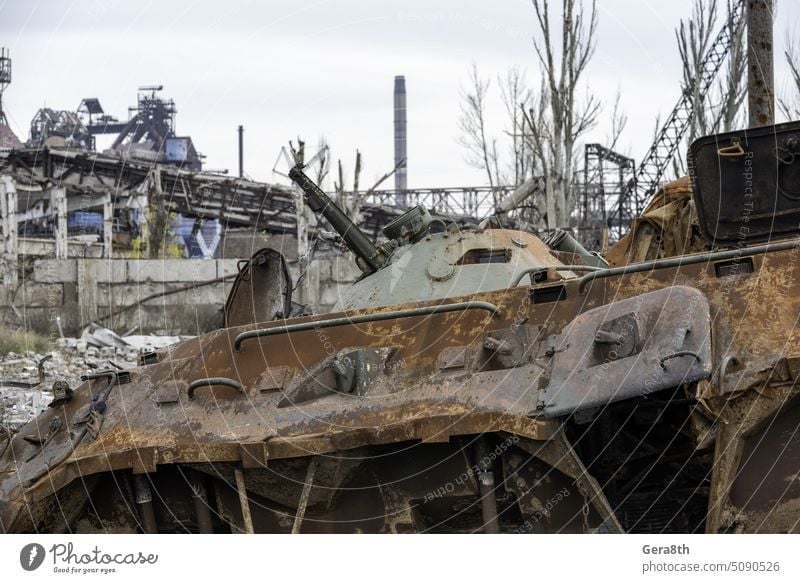 burnt tank and destroyed buildings of the Azovstal plant shop in Mariupol Russia Ukraine abandon army attack blackout blown up bombardment broken burned out