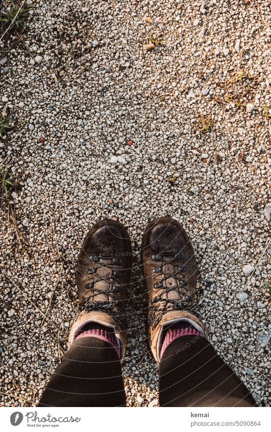 Feet in hiking boots from above Footwear Hiking boots Bird's-eye view Brown Leather leather boots Leather shoes socks leggings outdoor Gravel Street stones