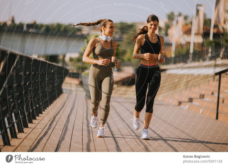 Young woman taking running exercise by the river promenade action active activity adult athlete athletic beautiful caucasian city exercising female fit fitness