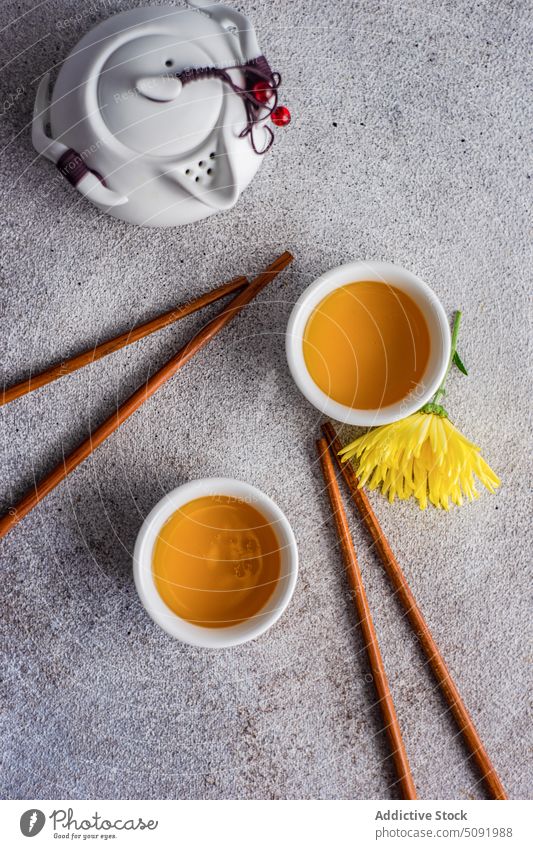 Asian green tea set with autumnal flowers Chrysanthemum asian asteraceae background beverage ceramic chopsticks chrysanths concrete cup drink fall time floral