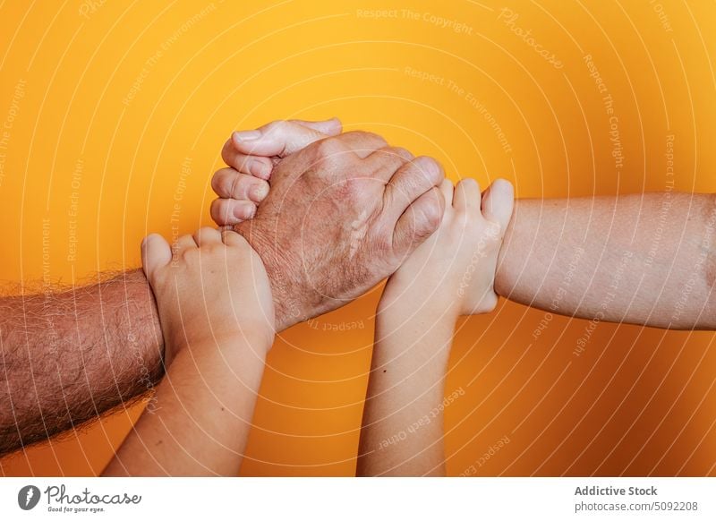 Crop multi generational people holding hands touch love relationship close support unity aged young children gesture trust solidarity equal bonding group tender