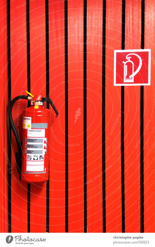 Red fire extinguisher on red wall Lecture hall Extinguisher wood Sign Signage Warning sign Threat Safety Protection Dangerous Living or residing Fire prevention