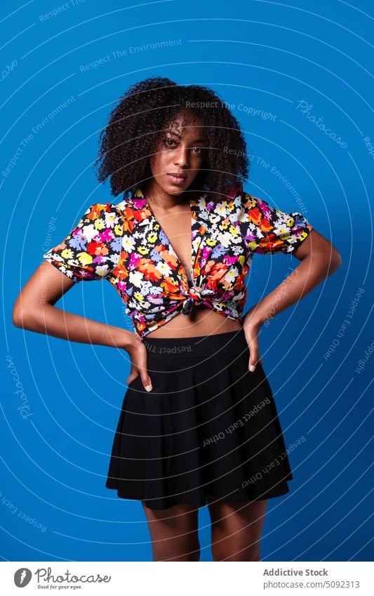 Young African American woman looking at camera style outfit model appearance modern individuality colorful bright portrait female young black african american