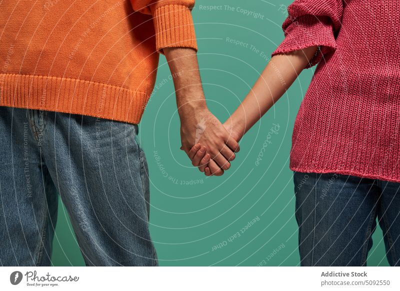 Anonymous non binary people holding hands model style together colorful appearance bright lgbt genderqueer androgynous individuality diverse multiracial