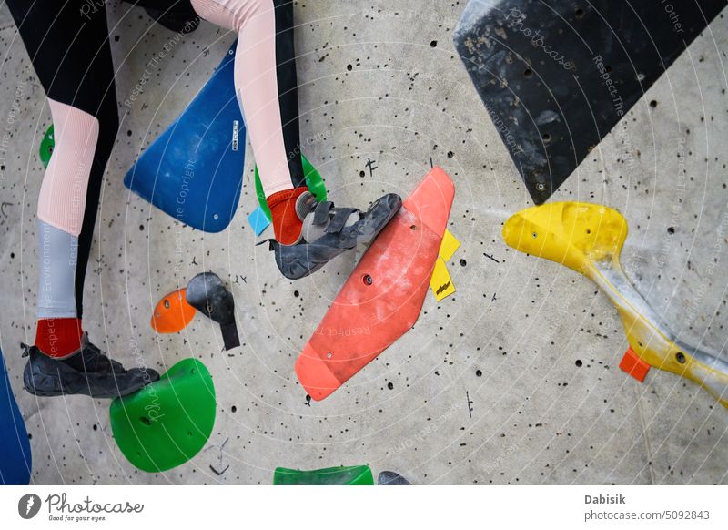 Woman training at bouldering gym. Active recreation, sports exercises extreme activity active climb woman motion fitness hobby lifestyle exercising climbing