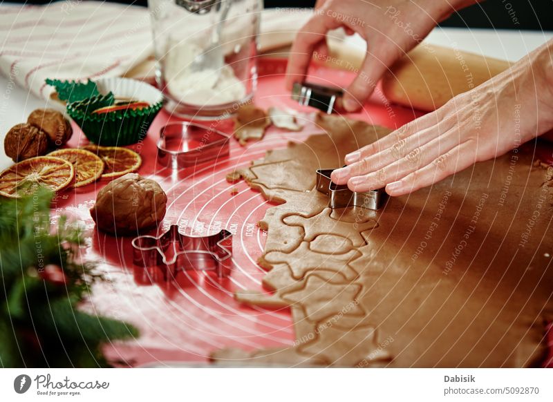 Process of woman making gingerbread cookies at home cooking cutter dough kitchen homemade christmas culinary food baking traditional holiday recipe biscuit