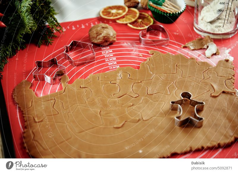 Raw dough for gingerbread cookies cutter cooking food holiday culinary shape man background christmas traditional silicone mat raw sweets close up cake bake