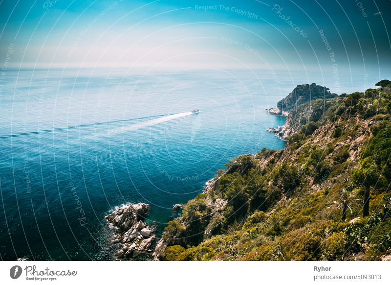 Tossa De Mar, Girona, Spain. Pleasure Touristic Boat Floating On Balearic Sea. Spring Spanish Nature With Summer Rocky Landscape And Seascape copy space rocky