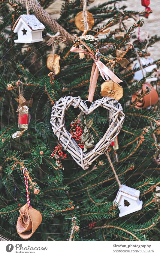 Christmas tree decorated with heart-shaped woven wreath and other handmade Christmas zero-waste ornaments christmas decoration vintage natural diy festive fir