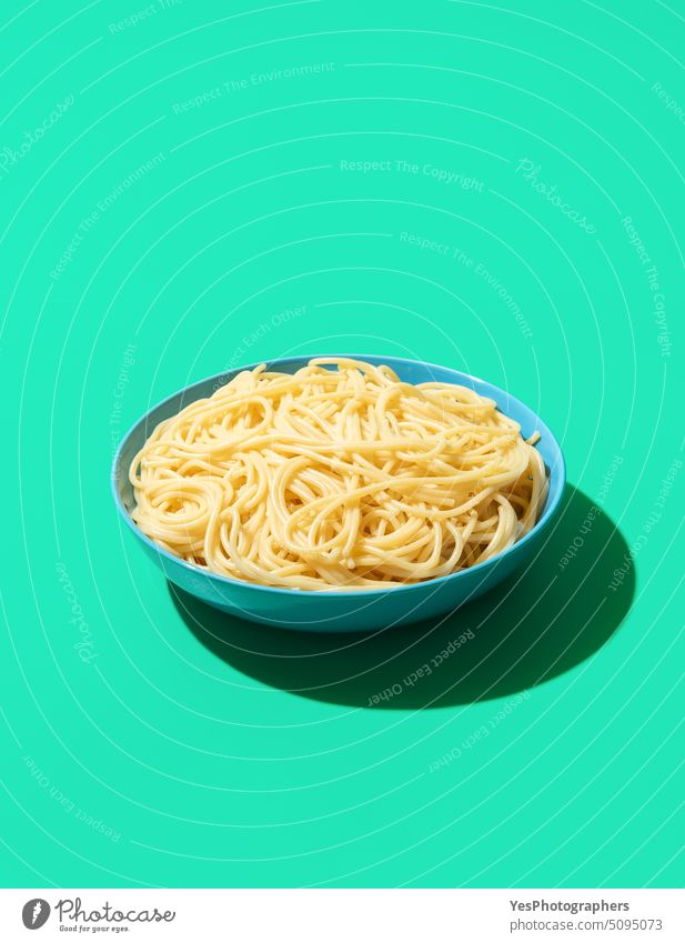 Spaghetti bowl isolated on a green background blue boiled bright carbs close-up color cooked cooking copy space creative cuisine cut out delicious design diet