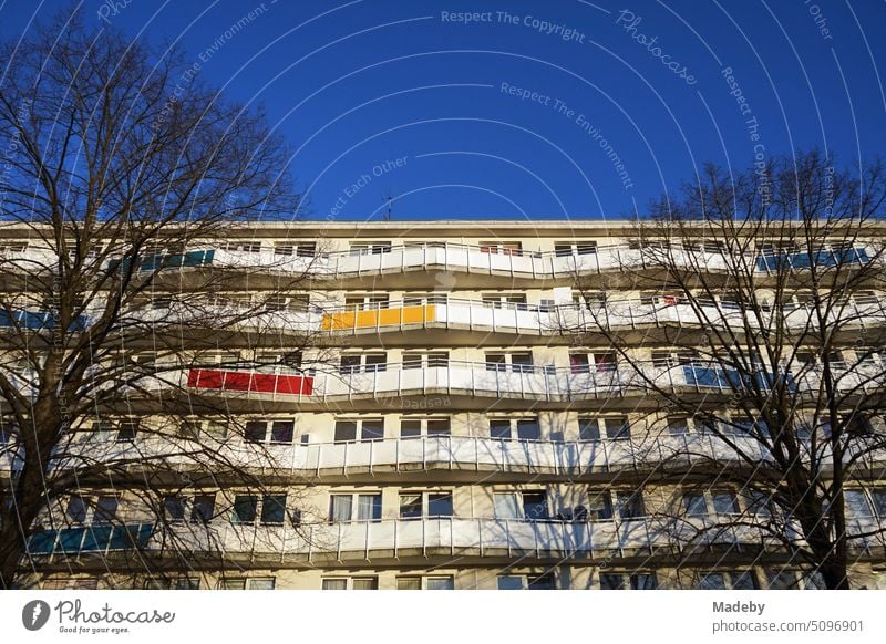 Renovated large apartment building with apartments and apartments in front of blue sky in the light of the setting sun in the southern town of Oerlinghausen on the Hermannsweg near Bielefeld in the Teutoburg Forest in East Westphalia-Lippe