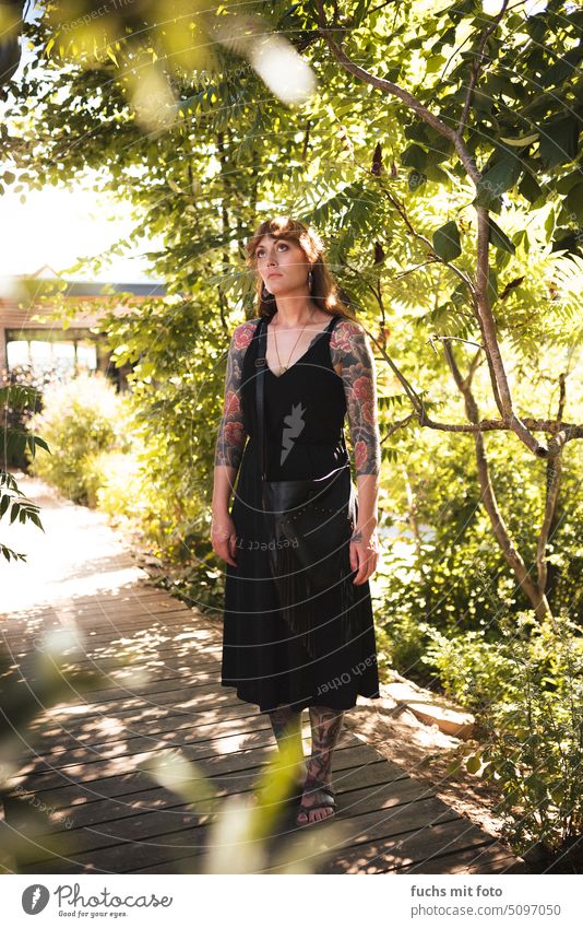 Young woman with tattoos and evening dress in nature Woman Tattoo pretty Summer Dress Evening dress Feminine Adults Human being Long-haired Youth (Young adults)