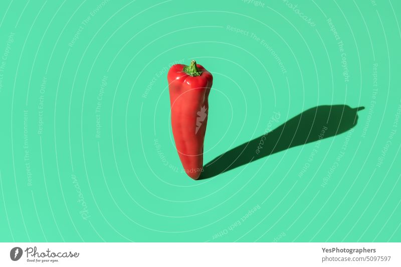 Sweet red pepper in bright light minimalist on a green background above abstract agriculture banner chili color colorful copy space cuisine cut out design diet