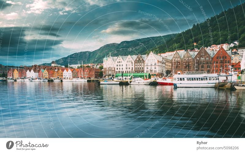 Bergen, Norway. View Of Historical Architecture, Buildings, Bryggen In Bergen, Norway. UNESCO World Heritage Site. Famous Street cityscape river mountain house
