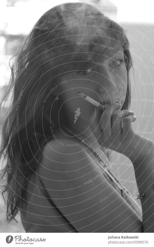 Portrait black and white of woman smoking Cigarette Retro Freedom Elegant Smoke black-white Evening dress Smoking jungles long hairs pretty Lifestyle portrait
