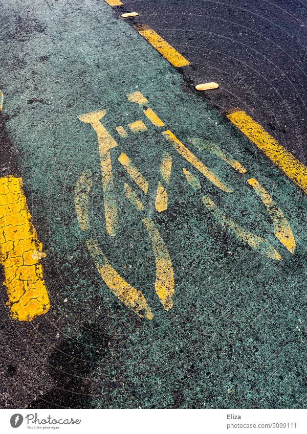 Yellow bicycle symbol on bicycle lane on the road Cycle path Street Bicycle Asphalt Traffic infrastructure Pictogram Lanes & trails Transport Lane markings Dark