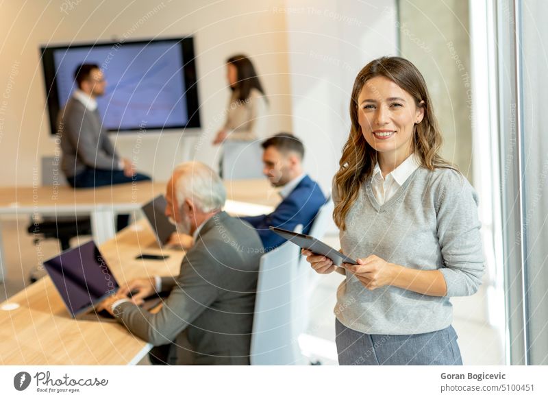 Young businesswoman in startup office with digital tablet in front of her team leader colleagues more adult Attractive pretty Beauty & Beauty Business