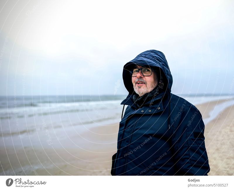 Portrait of elderly man in winter jacket by the sea Winter older adult Man Beach Baltic Sea Baltic coast Ocean Vacation & Travel Water Tourism Relaxation Nature