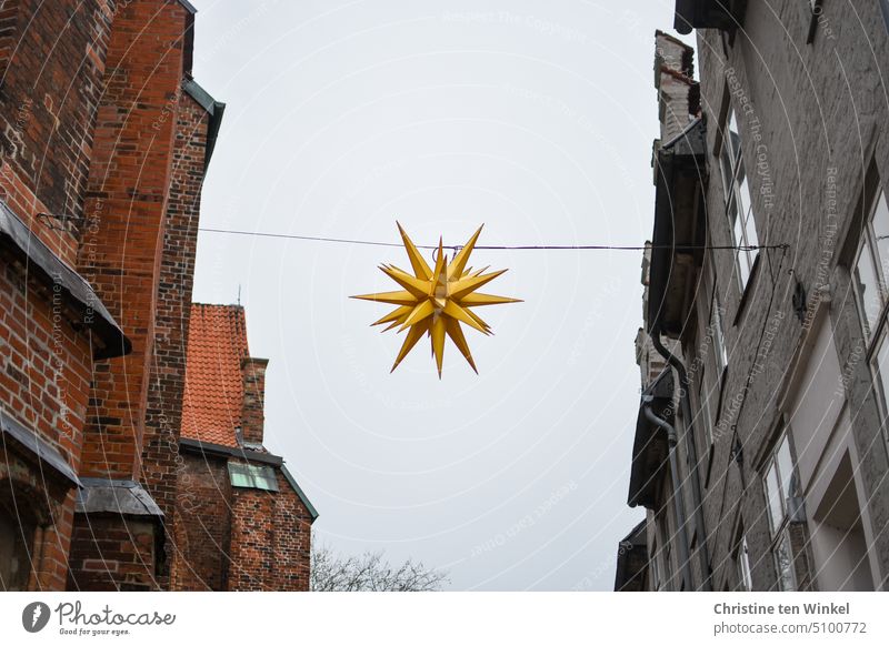 Christmas lights still remain off to save electricity Christmas fairy lights Star (Symbol) Herrnhuter Star Energy crisis switched off Town Facade Houses facade