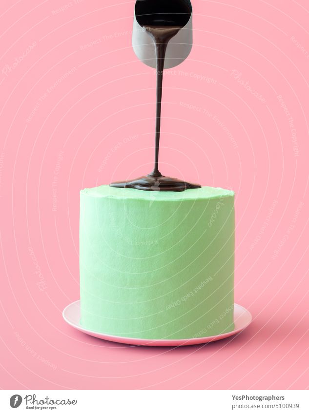 Pouring melted chocolate over peppermint cake, isolated on a pink background aroma banner birthday black buttercream celebration christmas close-up cocoa color