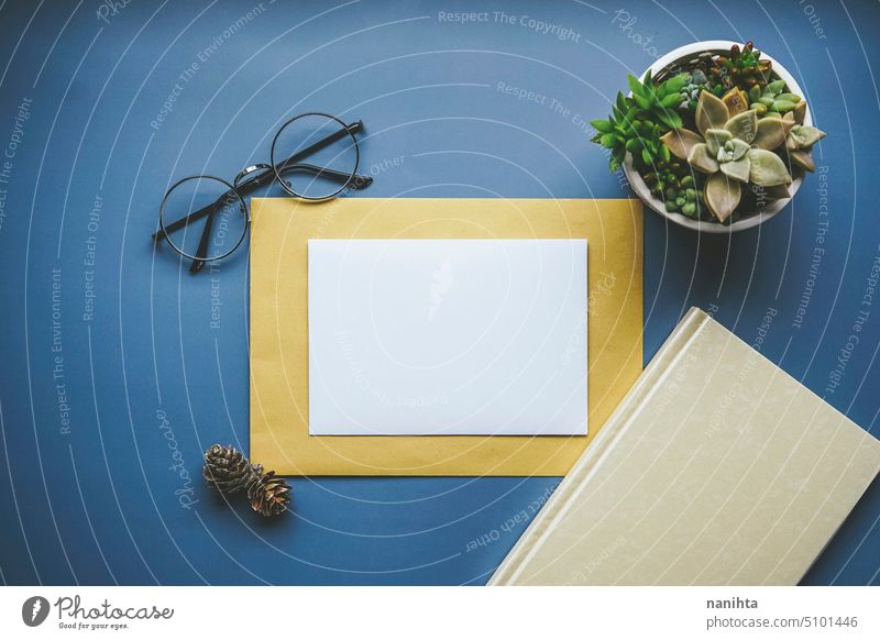 Professional flat lay with a frame of paper in centre of image mockup flatlay simple elegance minimal background office desktop envelope blank card white retro