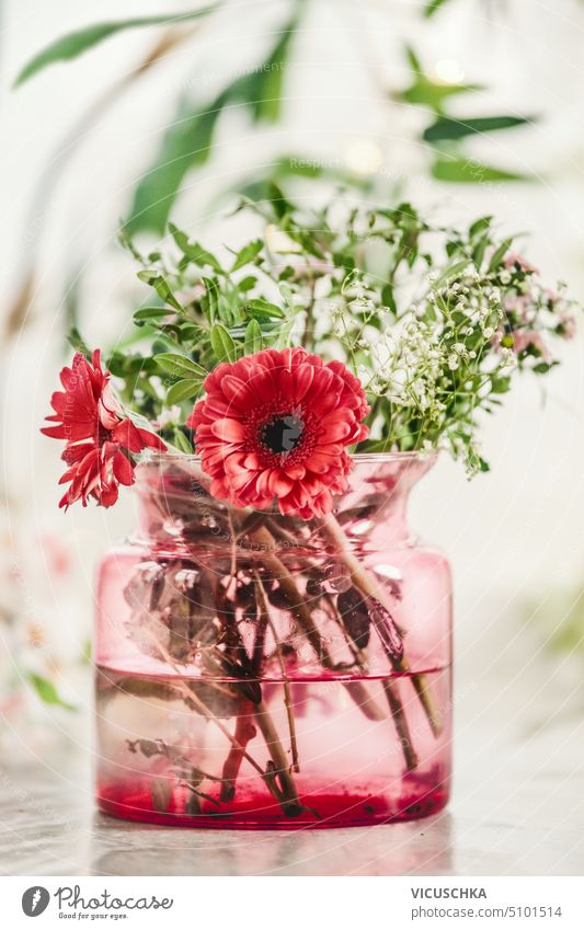 Flowers bunch in red glass vase on table, front view home elegance window romance bloom design floral flower bouquet arrangement white