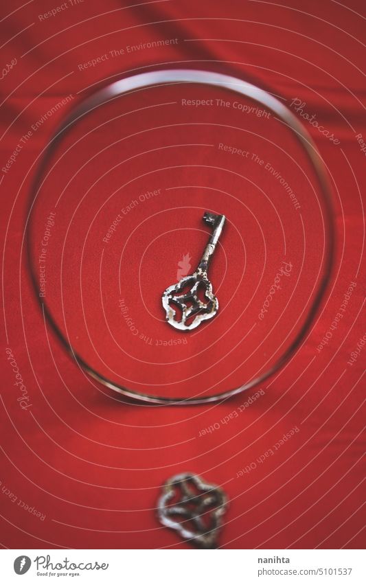 Minimal and conceptual image about secrets with a key against red background reflection minimal texture abstract close mystery mysterious intense mirror