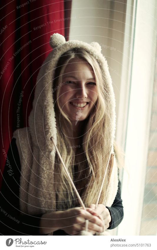 Close portrait of young blonde woman smiling and wearing fur vest with hood and ears Woman Young woman Blonde Long-haired Smiling Joy Vest Pelt